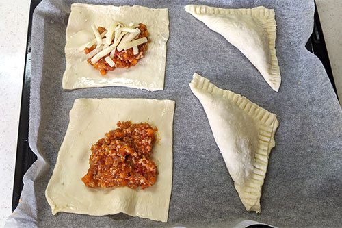 1. Half-thaw the frozen pie sheet, stretch it to a thickness of 2 to 3 mm, and divide it into 4 equal parts. Place "ground beef sauce with plenty of apples" on each of the pie sheets divided into four equal parts. <br>*Delicious with cheese if you like